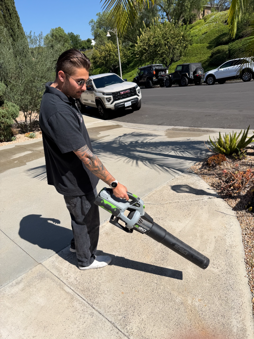 Dylan clearing debris with a leaf blower before the wash